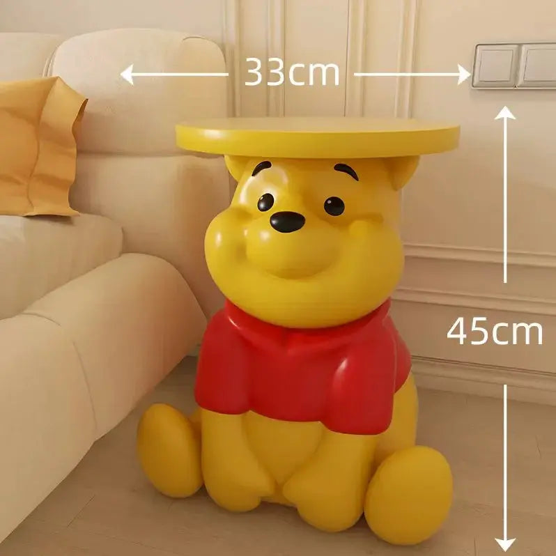 Whinnie the Pooh Yellow bear-shaped side table with dimensions labeled in a room setting.
