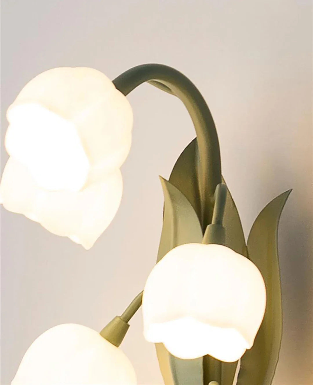 Decorative wall light fixture with tulip design on a plain background
