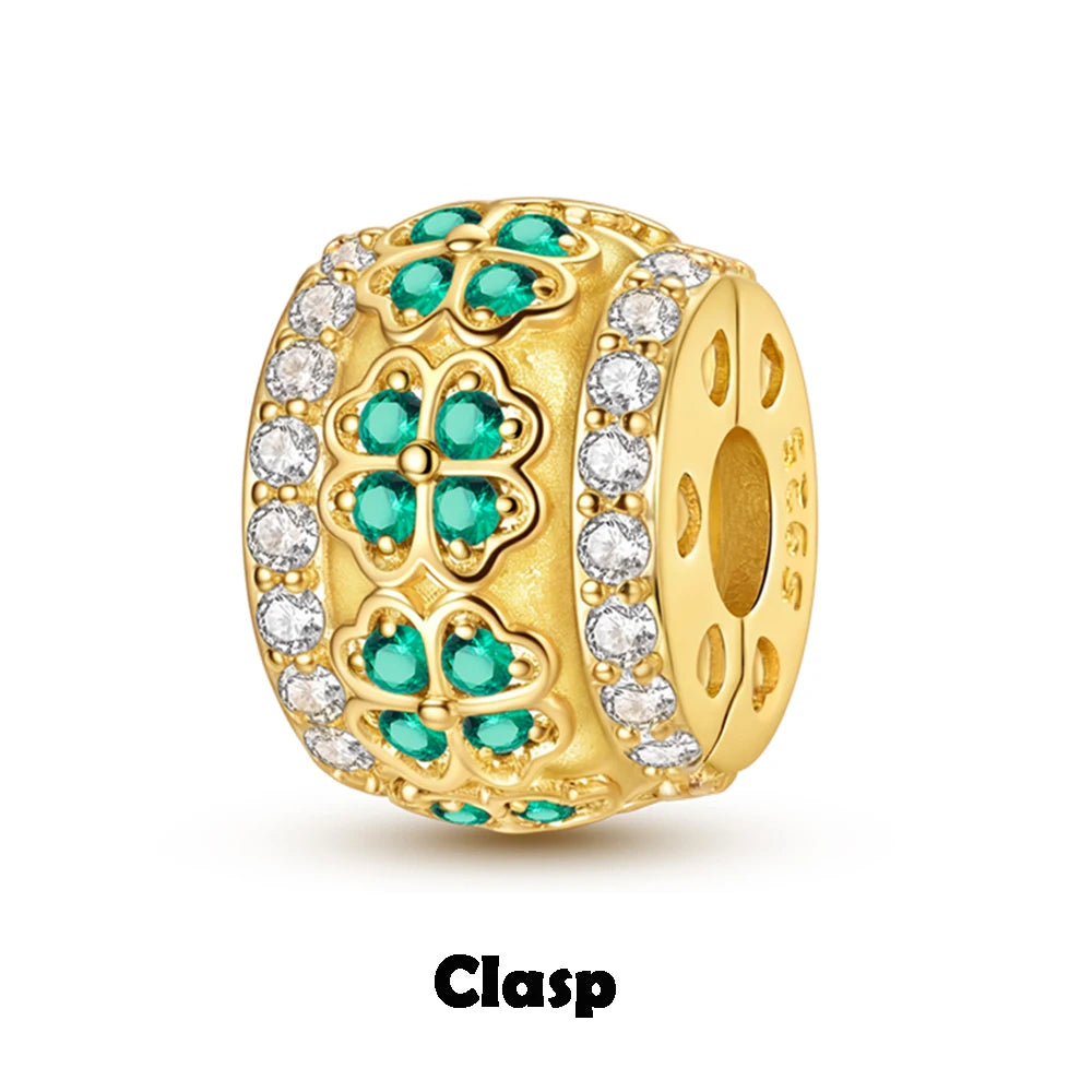 Gold clasp with emerald and diamond accents on a white background