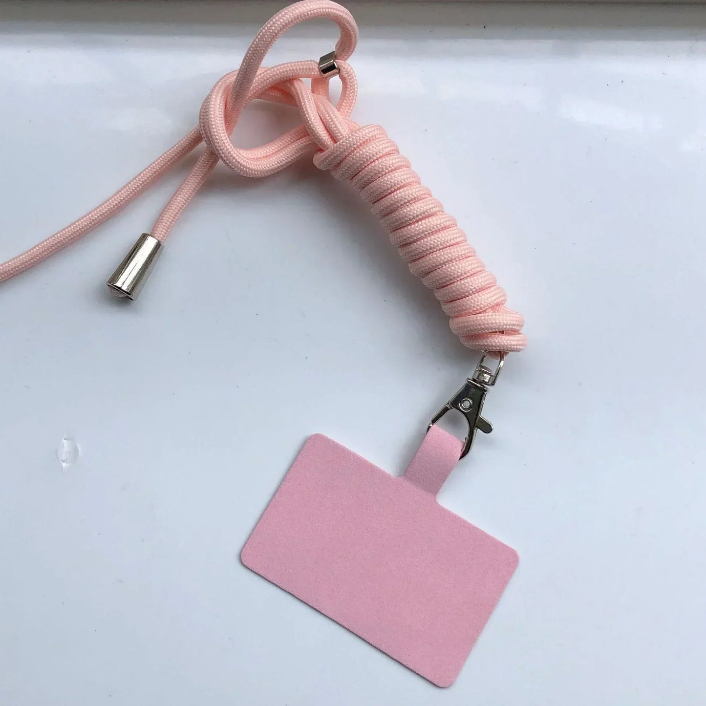 Pink lanyard with a detachable badge holder on a white background
