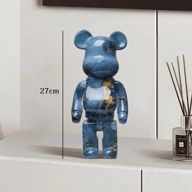 Blue marble-patterned bear figure on a white surface with a diffuser in the background be@rbrick collectable