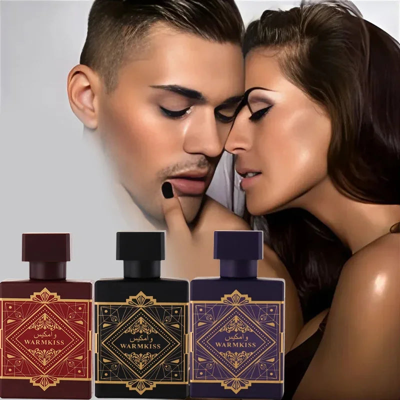Two people close together with three perfume bottles in front of them.