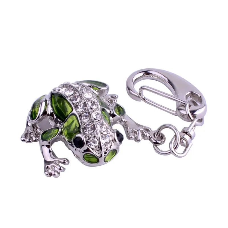 Green frog-shaped keychain with a silver clasp on a white background
