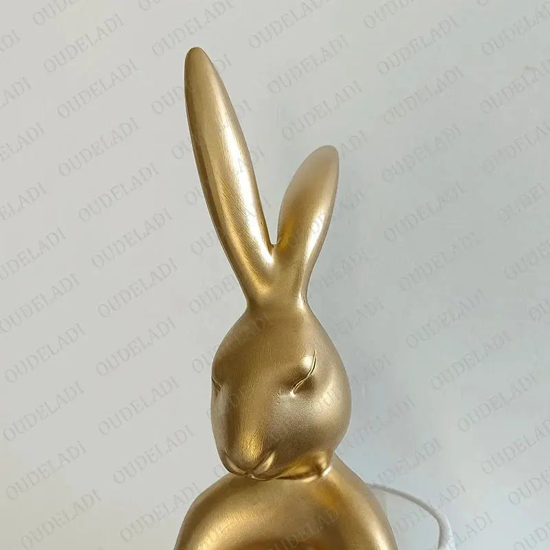 Gold rabbit-shaped lamp on a white background