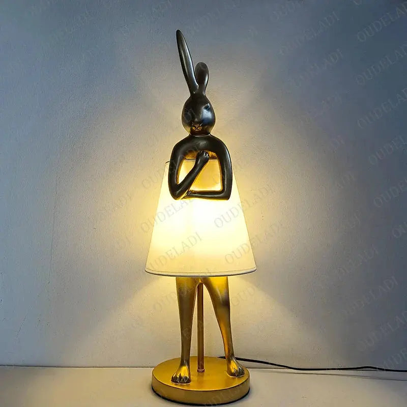 Decorative table lamp with rabbit design on a plain background