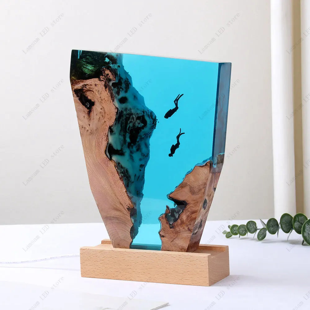 Decorative piece with a wooden base and blue resin design, resembling underwater scene. deep sea scuba divers