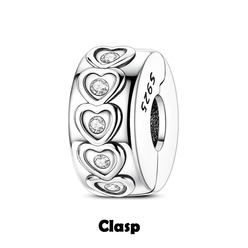 Silver clasp with heart designs and clear stones on a white background