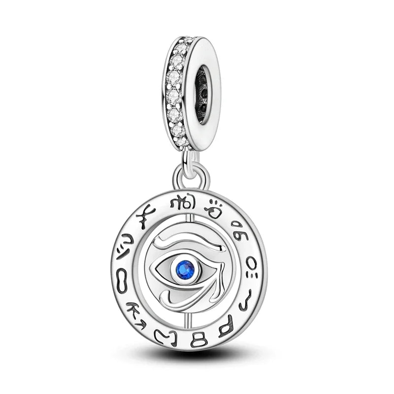 Evil Eye Silver charm with eye design and blue gemstone on a white background