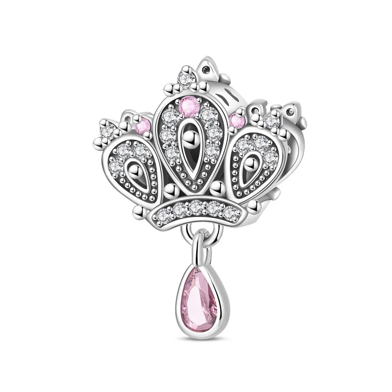 Silver charm with pink teardrop and crown design on a white background