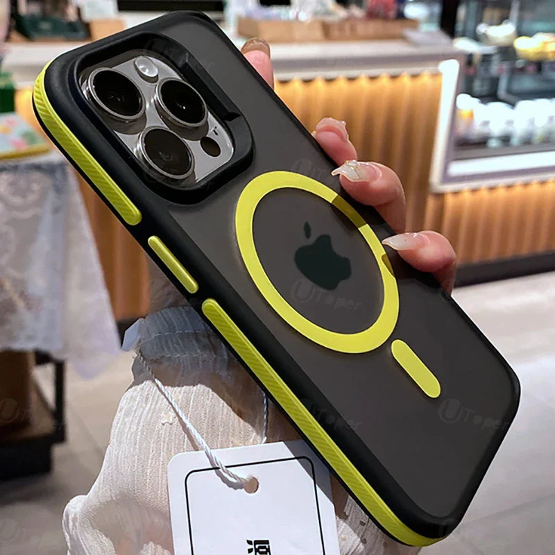 Phone case with black and yellow design held by a person, blurred indoor background