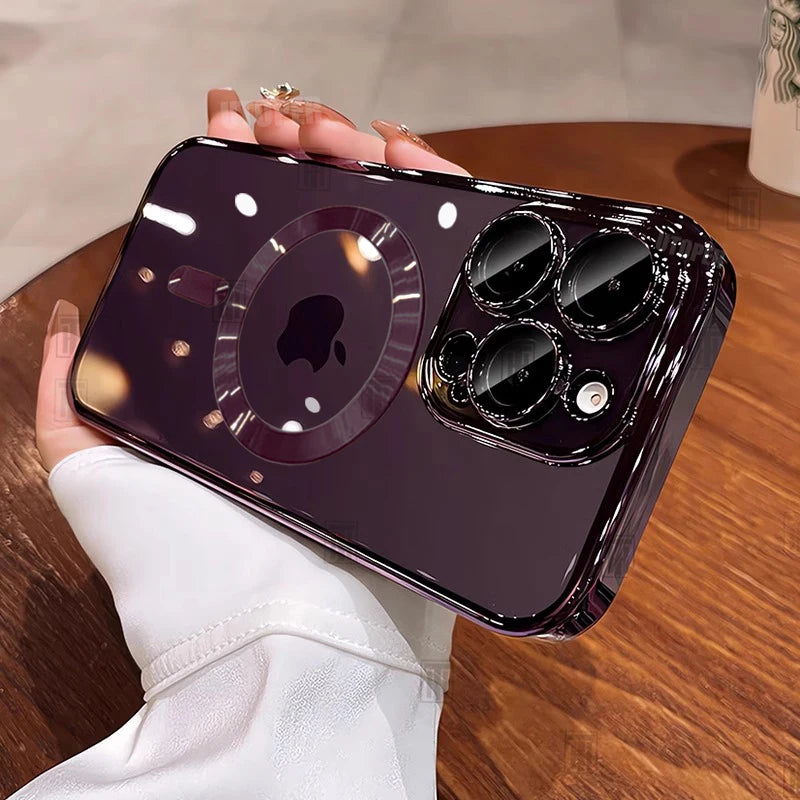 Person holding a phone with a reflective black case on a wooden surface