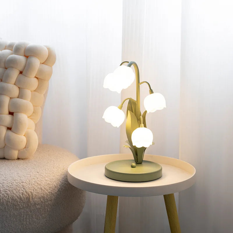 Modern table lamp with multiple lights on a small round table next to a textured chair.