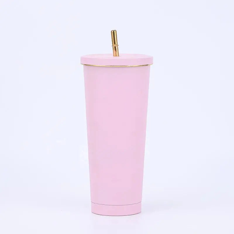 Pink tumbler with a gold straw on a white background
