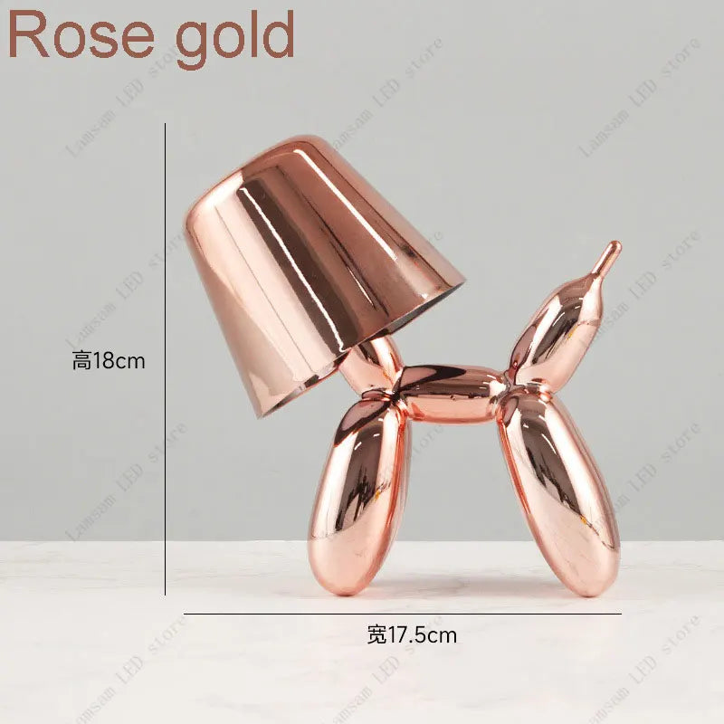 Rose gold balloon dog sculpture with dimensions on a light gray background