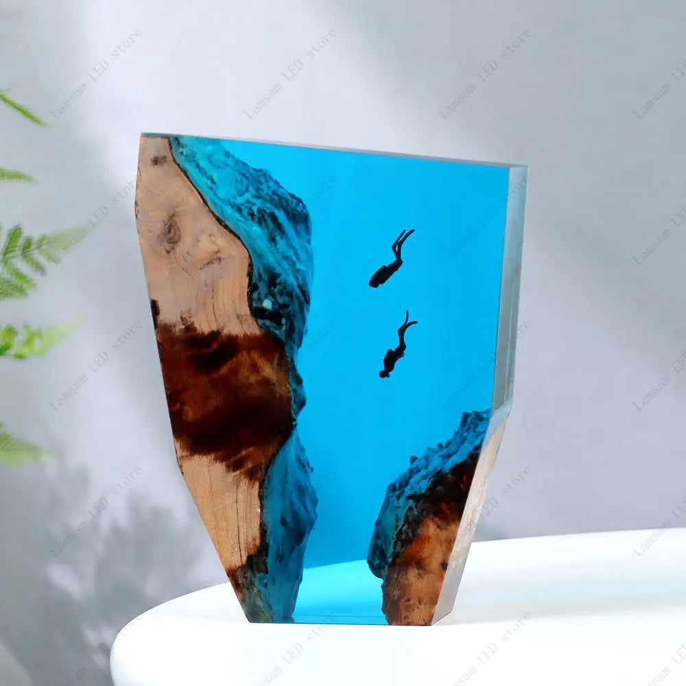 Decorative piece with blue resin and wood on a white surface scuba divers deep sea