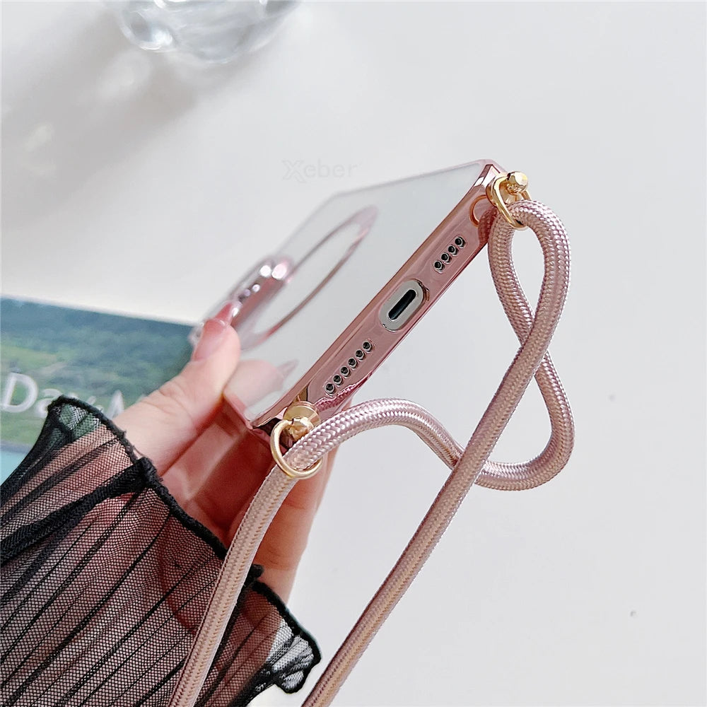 Phone case with a strap held by a hand on a light background