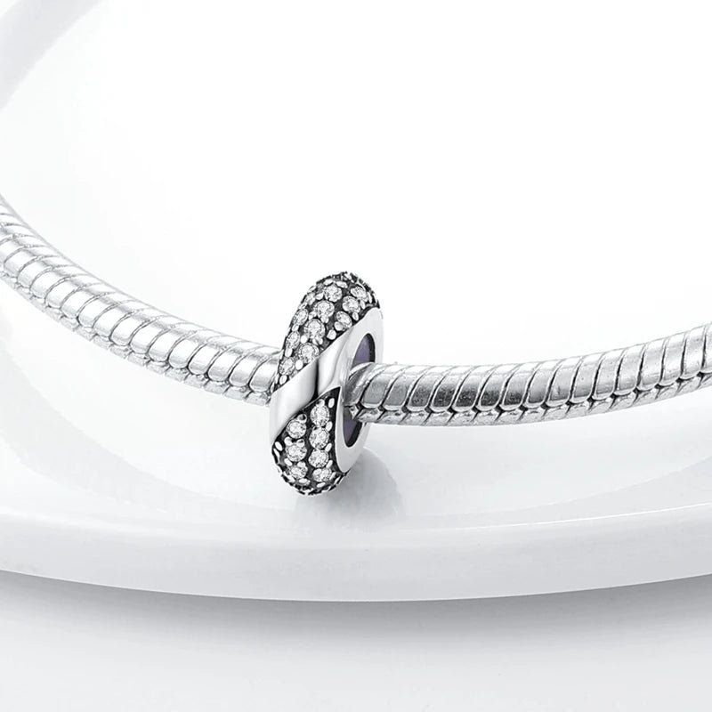 Silver bracelet with a close-up of a clasp on a white background
