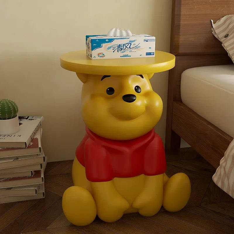 Whinnie the Pooh kids Yellow bear-shaped side table with a box of tissues on top, in a room setting.
