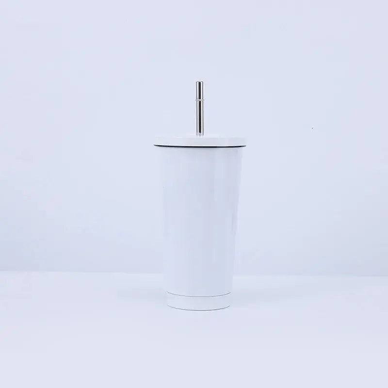 White tumbler with a black rim and silver straw on a light purple background