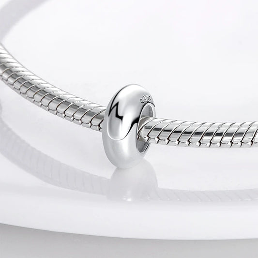 Close-up of a silver bracelet on a white background
