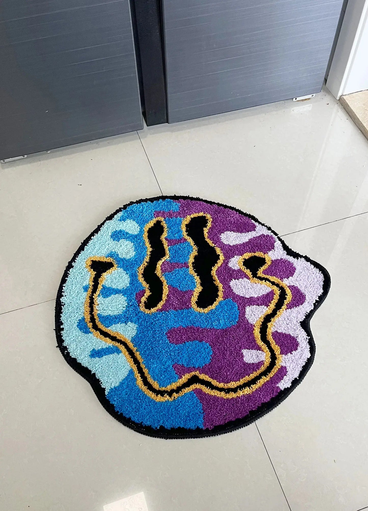 Colorful doormat with abstract design on a tiled floor