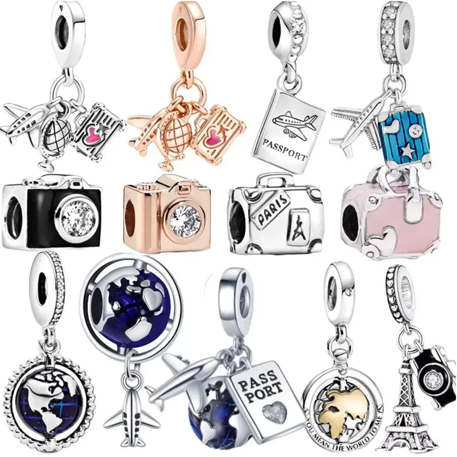 Collection of travel-themed charms on a white background