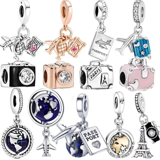 Collection of travel-themed charms on a white background