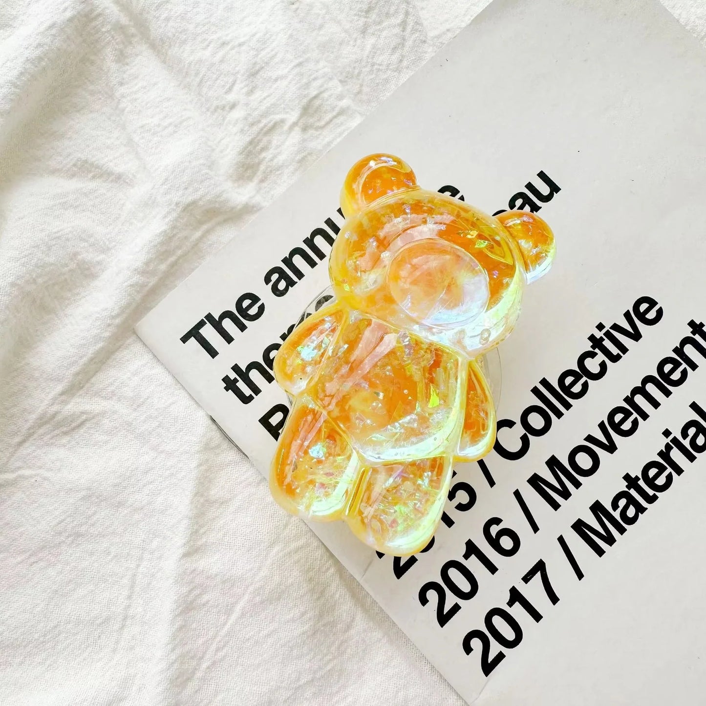 Gummy bear-shaped candy on a book with text