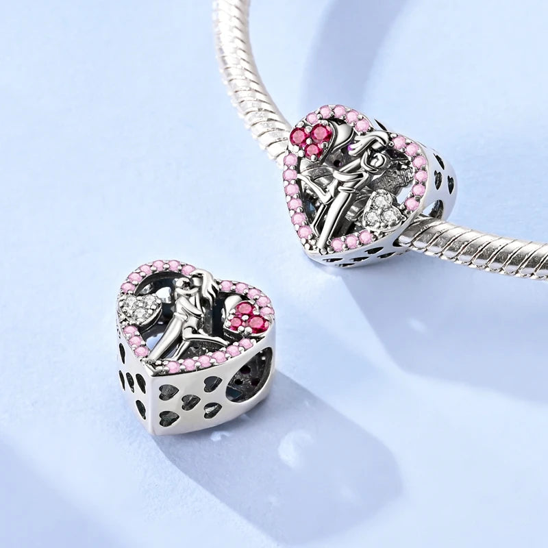 Heart-shaped silver and pink charm on a light blue background. pandora style