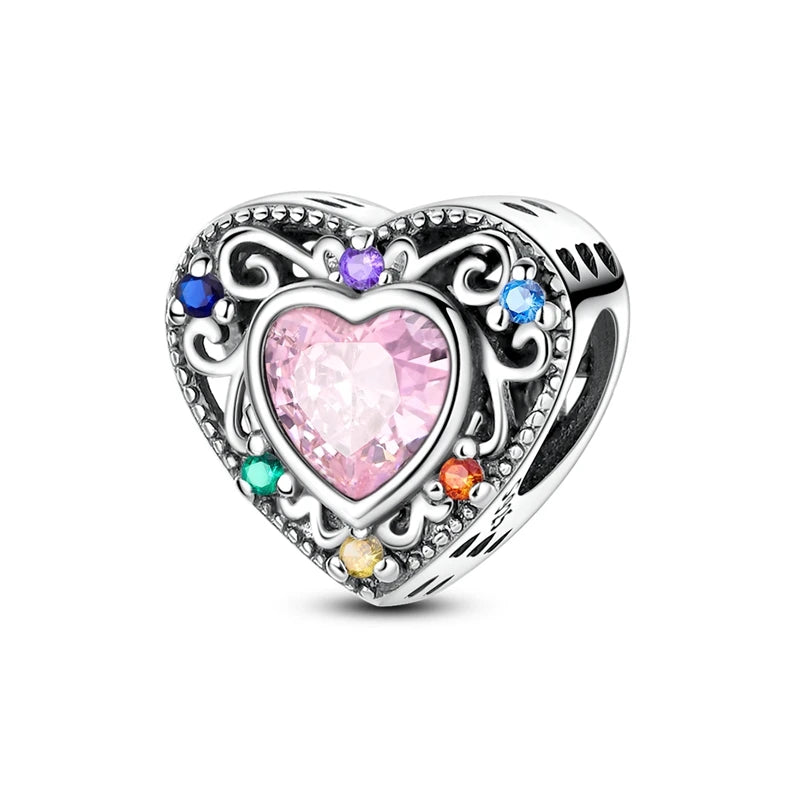 Heart-shaped charm with pink center and multicolored stones on a white background