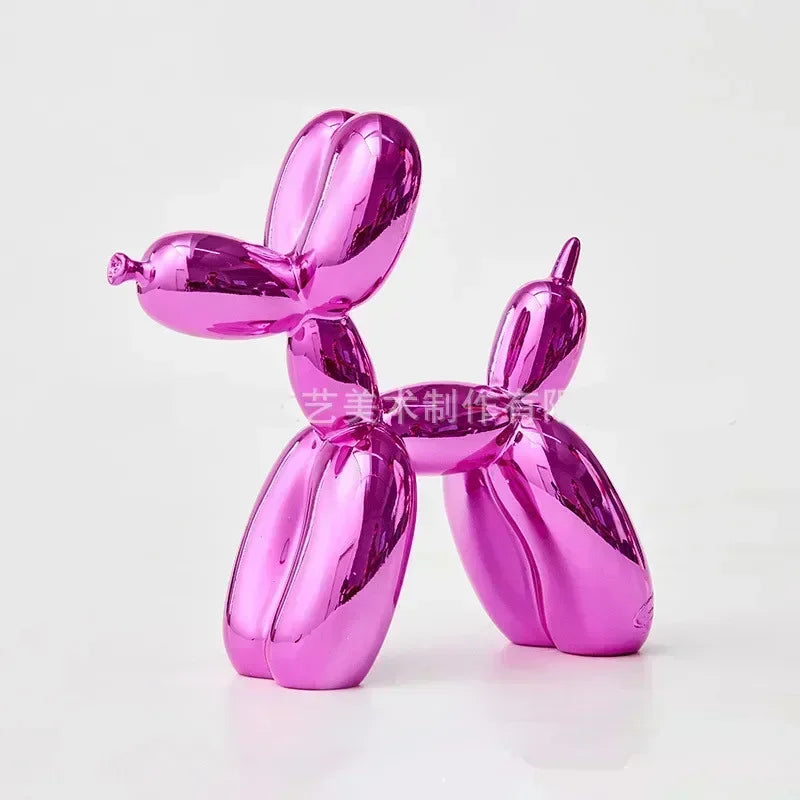 Shiny pink balloon dog sculpture on a white background