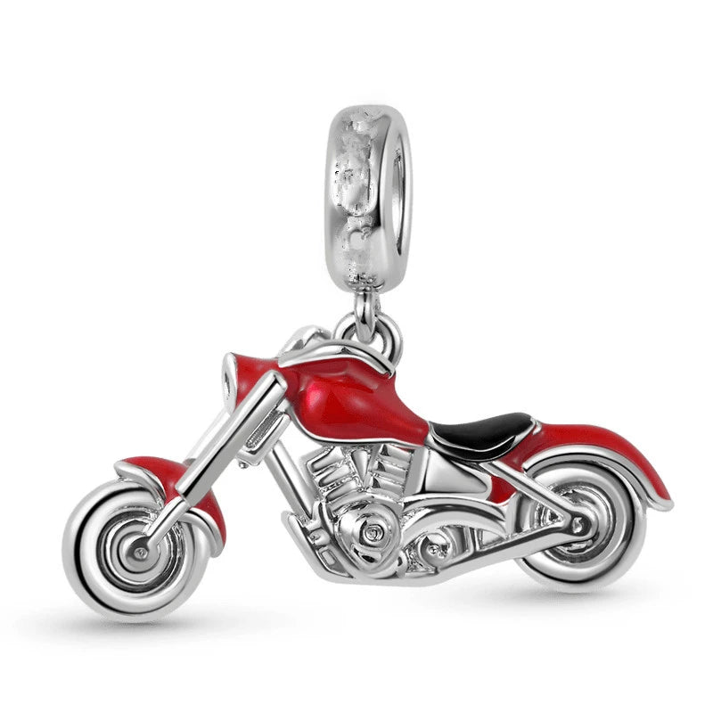 Motorcycle-shaped charm with red and black details on a white background