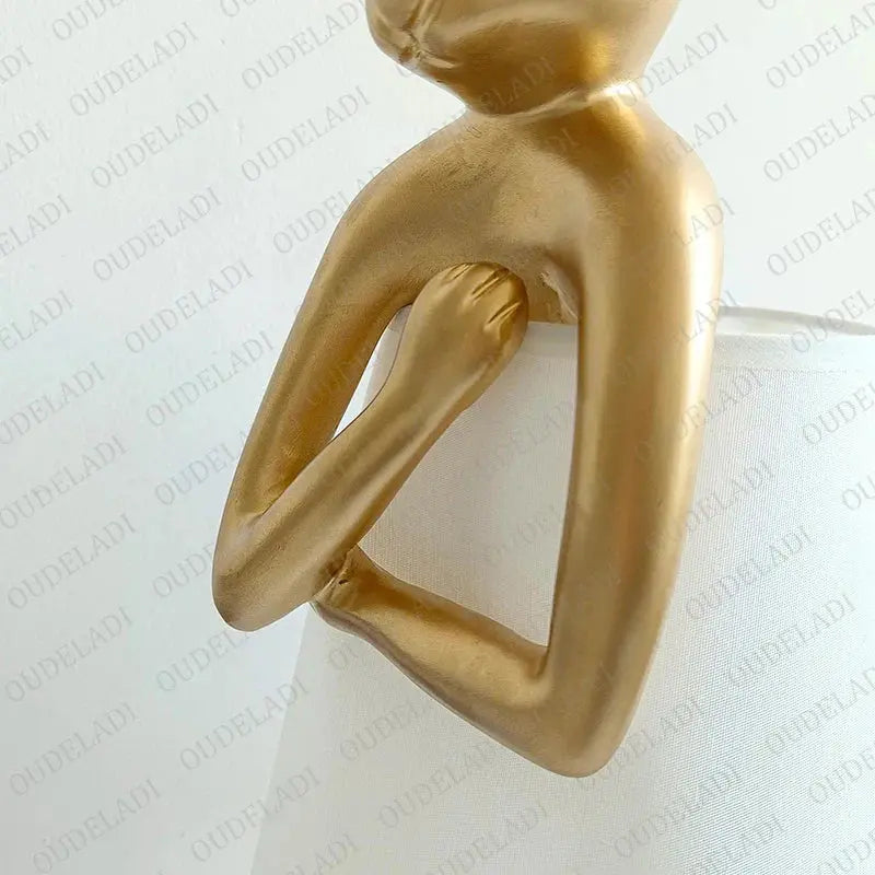 Gold abstract sculpture on a white background
