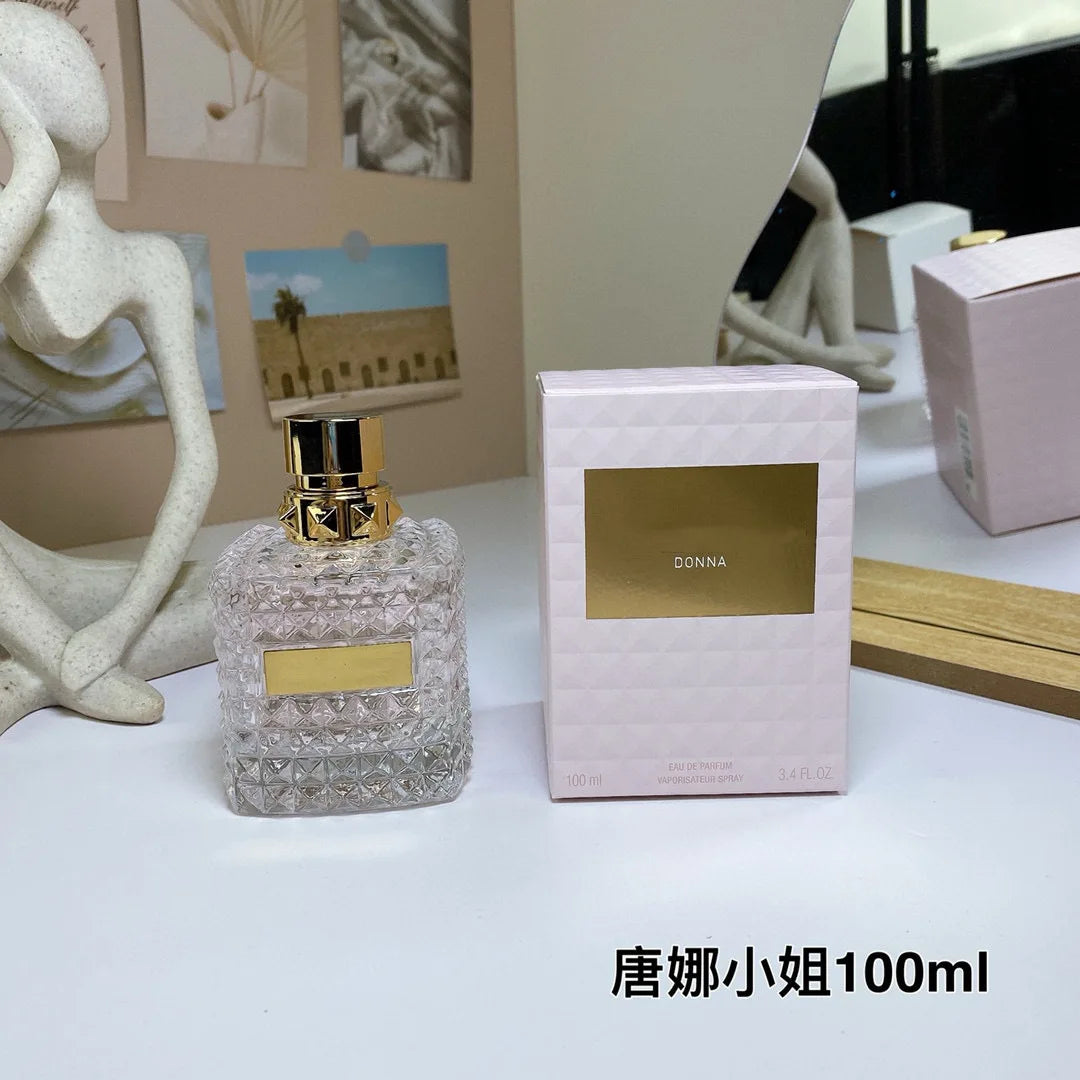Valentino Perfume bottle and packaging with 'DONNA' branding on a decorative surface.