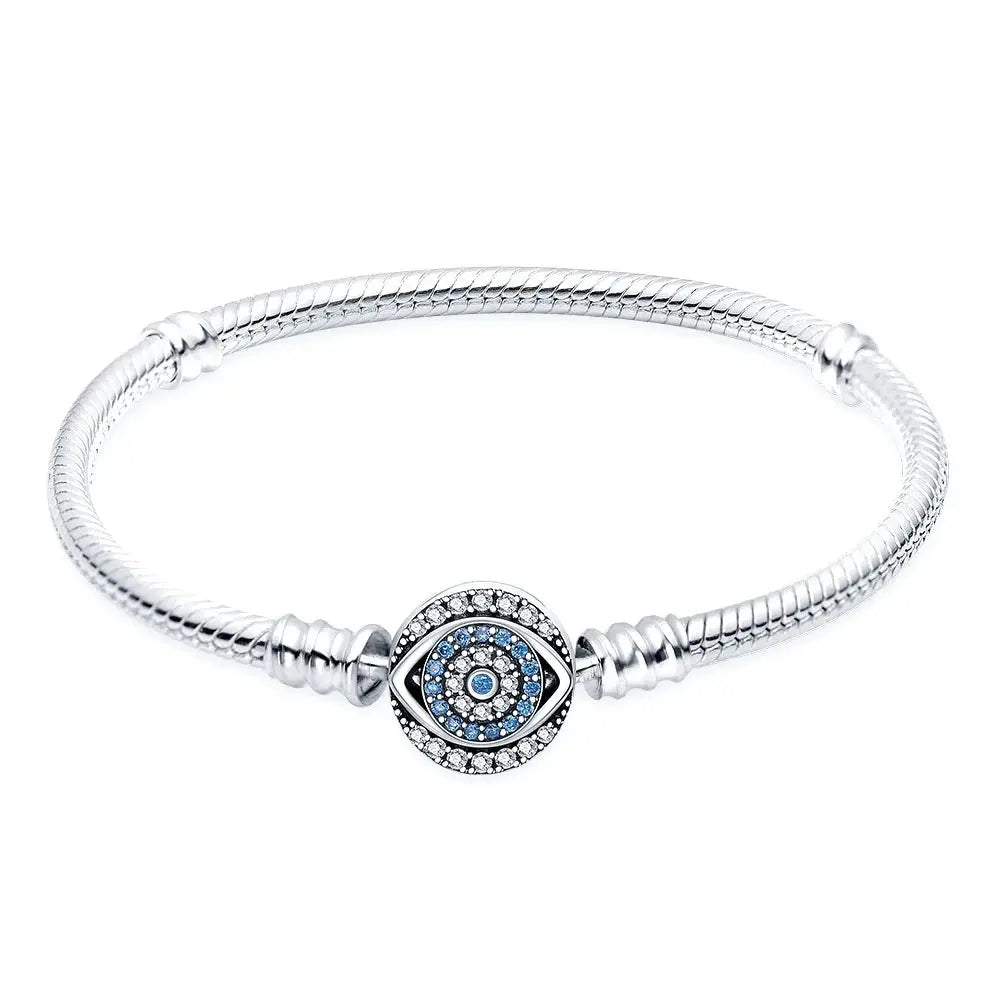 Silver bracelet with a blue evil eye charm on a white background