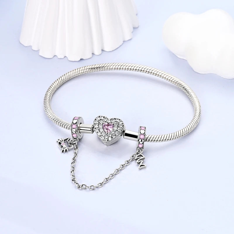 Silver bracelet with heart-shaped charm and pink accents on a light purple background. pandora style