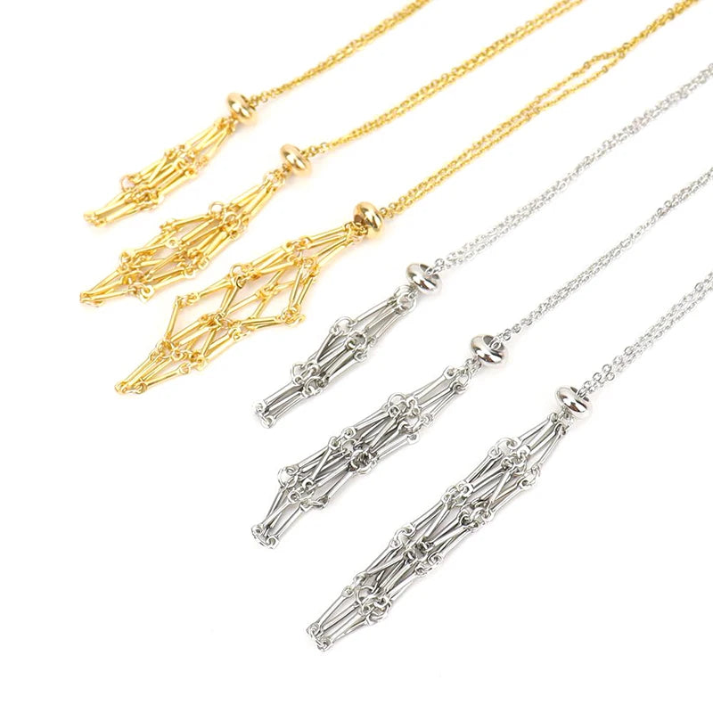 Two gold and two silver necklaces with intricate pendants on a white background
