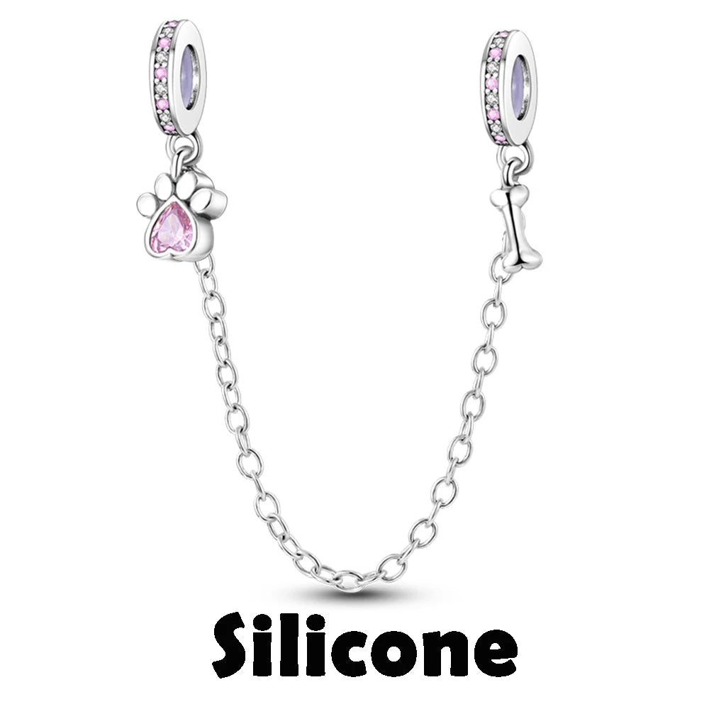 Silver charm with pink gem and chain on a white background, featuring the brand 'Silicone'.
