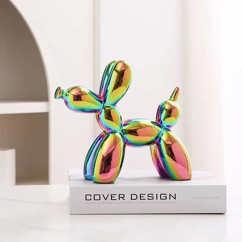 Multicolored balloon dog sculpture on a white surface with 'Cover Design' text in the background