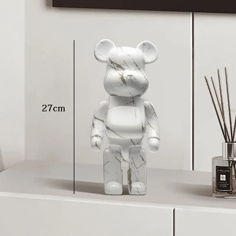 Marble-patterned bear figure on a white surface with a diffuser in the background be@rbrick collectable