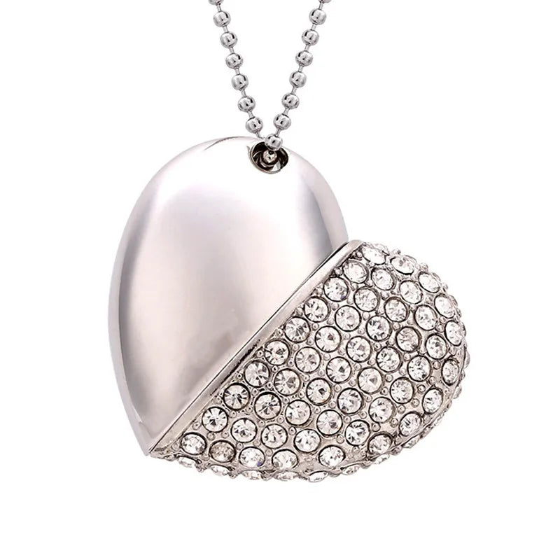 Heart-shaped pendant with one half silver and the other half covered in crystals on a white background
