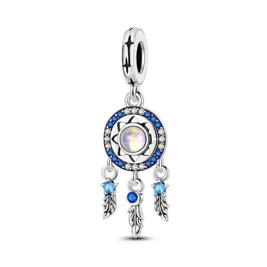 Silver charm dream catcher with a central gemstone and blue accents on a white background