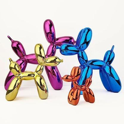 Four colorful balloon dog sculptures in gold, pink, blue, and orange on a white background.