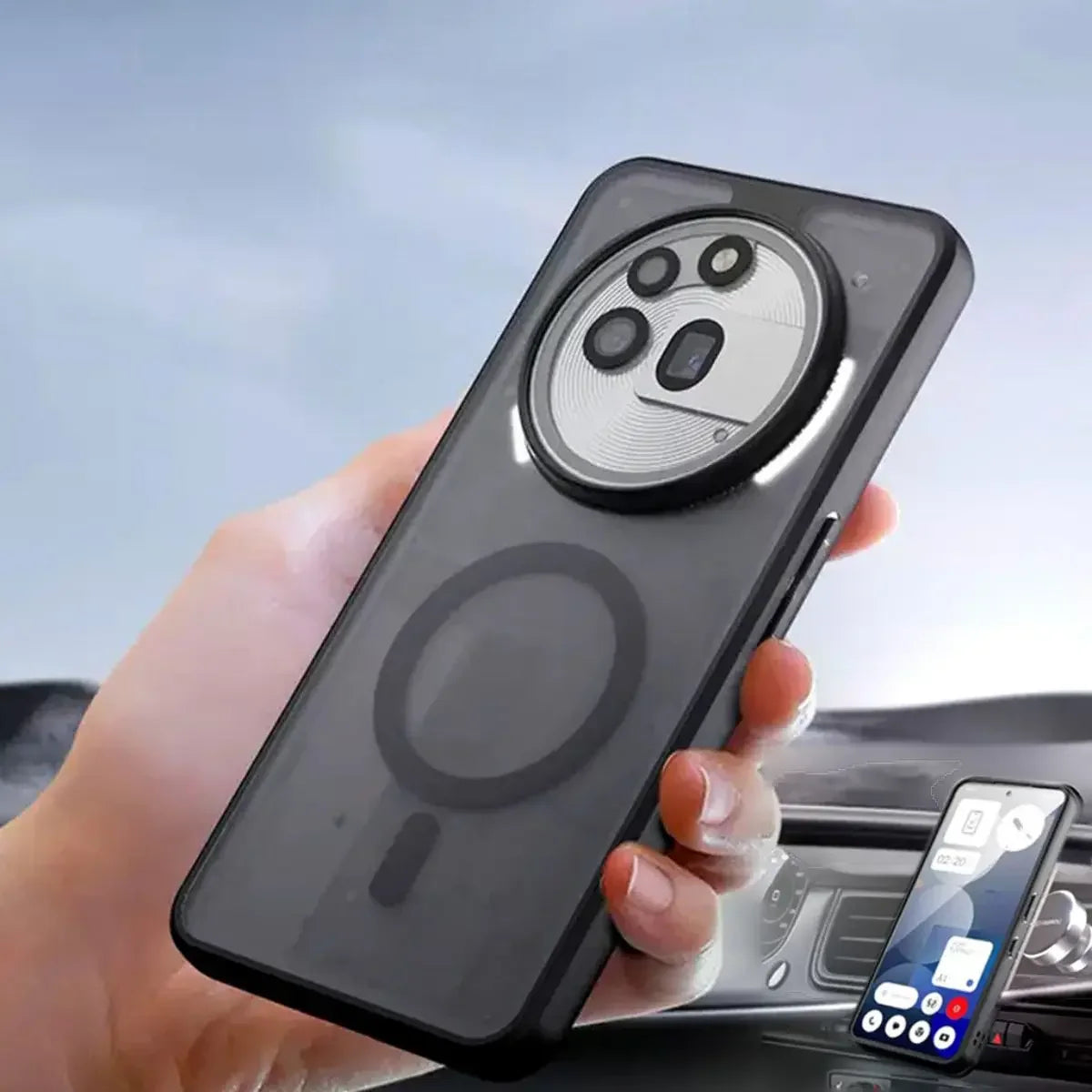 Person holding a smartphone with a clear case, showing a car interior in the background.