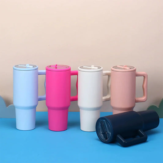 Colorful 40 oz tumblers with flip straw lids shown upright and sideways, compatible with Stanley Quencher, reusable and spill proof