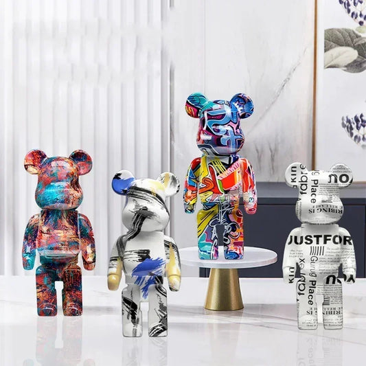 Four colorful bear-like sculptures on a white surface with a minimal background be@rbrick collectable