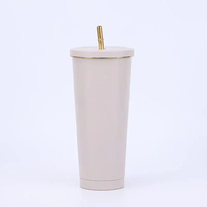 Beige tumbler with a gold straw on a white background