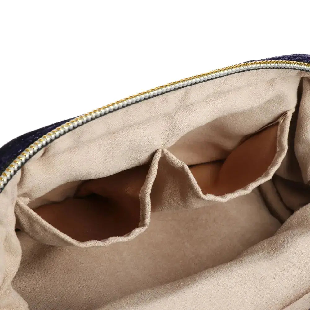 Close-up of a beige pouch with a zipper, showing the interior.
