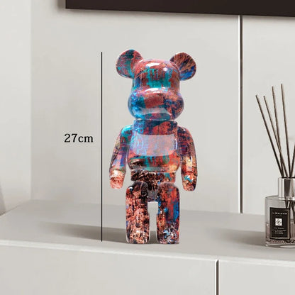 Colorful bear-shaped figure on a white surface with a measurement label, next to a diffuser. be@rbrick collectable