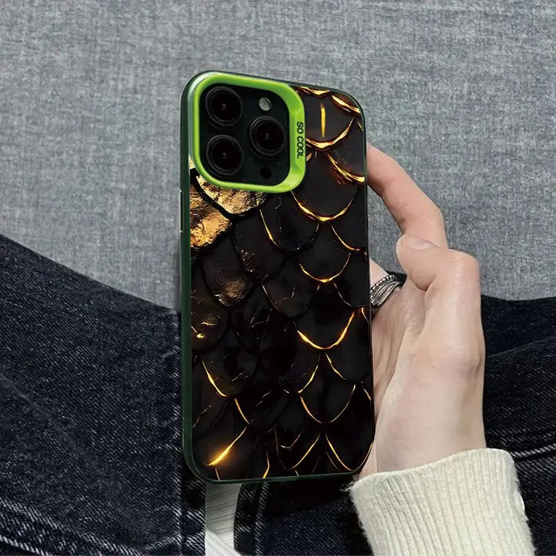 Phone case with dragon scale design held by a person against a gray background